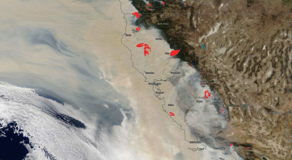 satellite image of California, half obscured by smoke emanating from a half dozen large areas, including two in the Sierra Nevada.